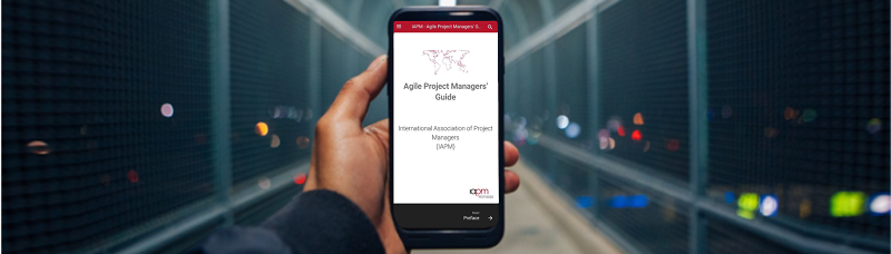 Person holding smartphone on which the IAPM Agile Project Managers' Guide page is open. [1]