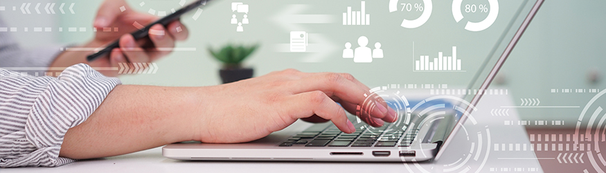 Person typing on a laptop with one hand and holding a mobile phone in the other. Person typing on a laptop with one hand and holding a mobile phone in the other.