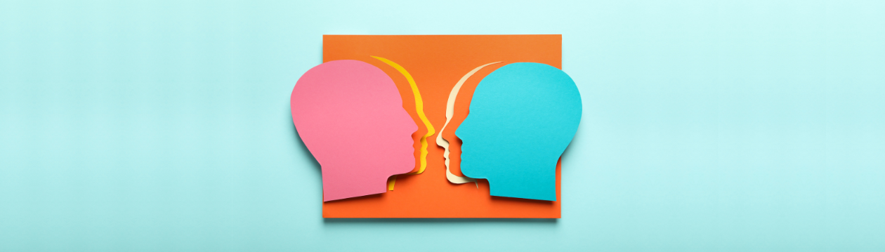Several paper silhouettes of heads in different colours.