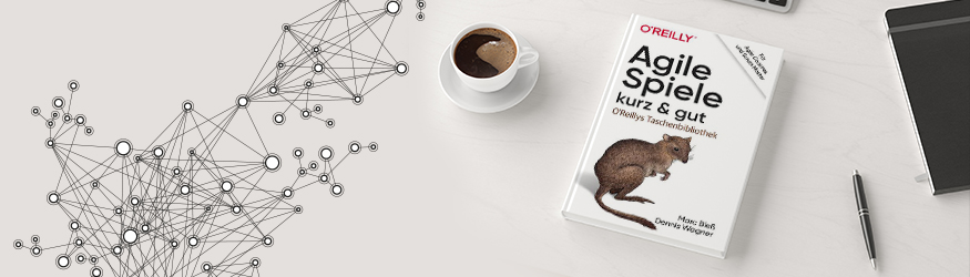 A book titled Agile Spiele and a cup of coffee. A book titled Agile Spiele and a cup of coffee.