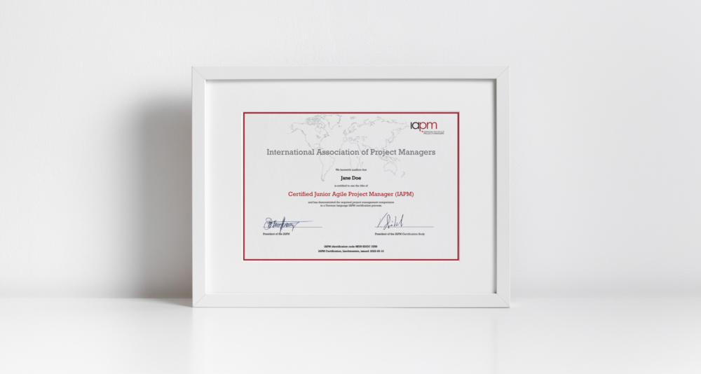 The Certified Junior Agile Project Manager certificate is in a white picture frame on a white surface.