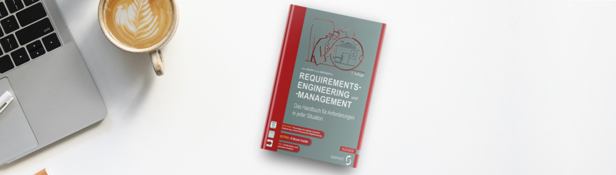 Chris Rupp's book "Requirements-Engineering und -Management" lies on a table next to a laptop and a cappuccino Chris Rupp's book "Requirements-Engineering und -Management" lies on a table next to a laptop and a cappuccino