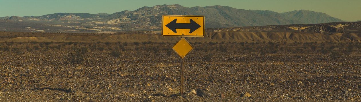 Road signs with directional arrows in a desert. Road signs with directional arrows in a desert.