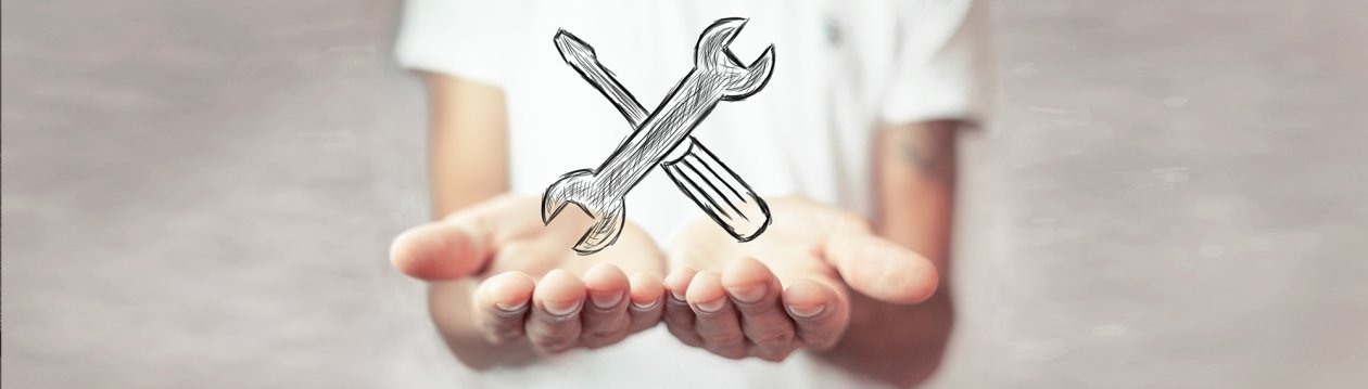A person in white shirt holds his hands open, a screwdriver and a wrench are drawn floating above.