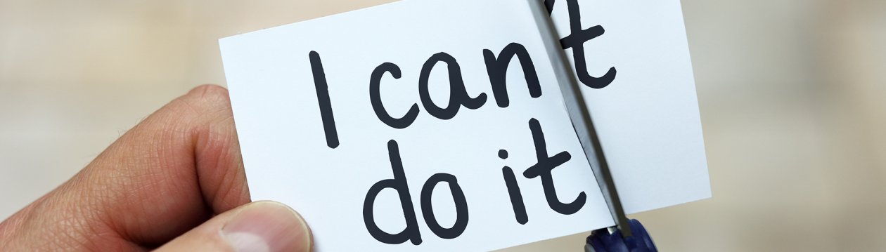 Auf einem Zettel steht "I can't do it", was von einer Schere zu "I can do it" beschnitten wird Auf einem Zettel steht "I can't do it", was von einer Schere zu "I can do it" beschnitten wird