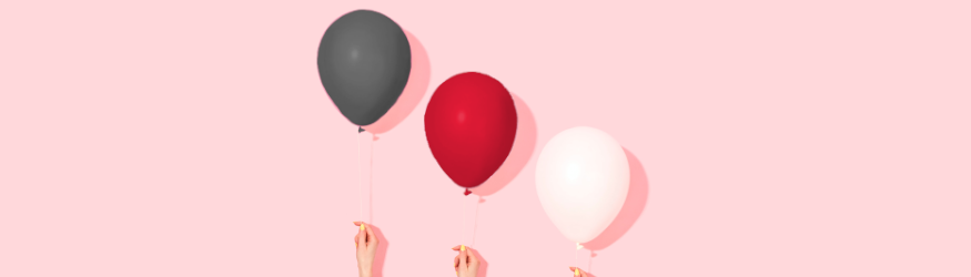 Three balloons against a pink background.