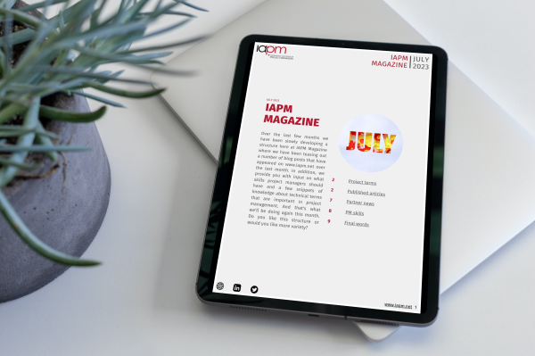 Tablet lying next to a plant on a table, showing the cover of IAPM Magazine July. Tablet lying next to a plant on a table, showing the cover of IAPM Magazine July.