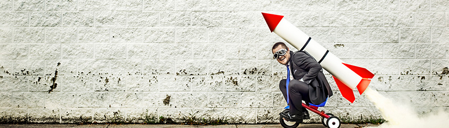 Businessman on a tricycle with a rocket on his back. Businessman on a tricycle with a rocket on his back.