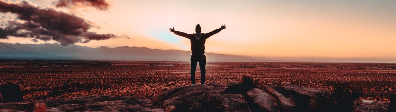 Motivation - A man is standing on a mountain.