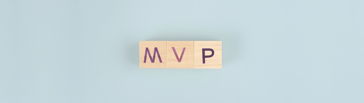 Wooden blocks with the inscription ‘MVP’ on a blue background. Wooden blocks with the inscription ‘MVP’ on a blue background.