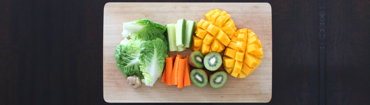 A board with fruit and vegetables on it. A board with fruit and vegetables on it.