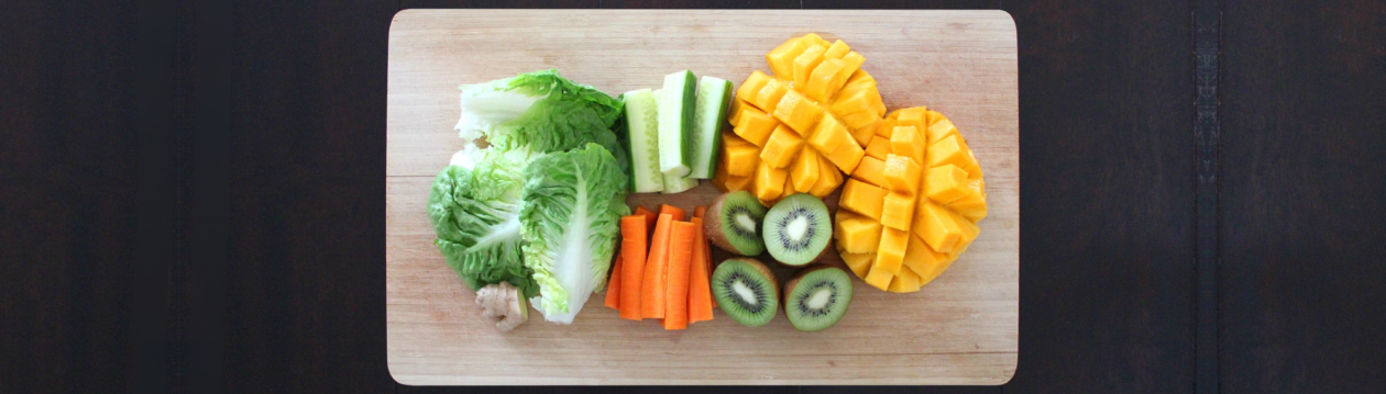 A board with fruit and vegetables on it.