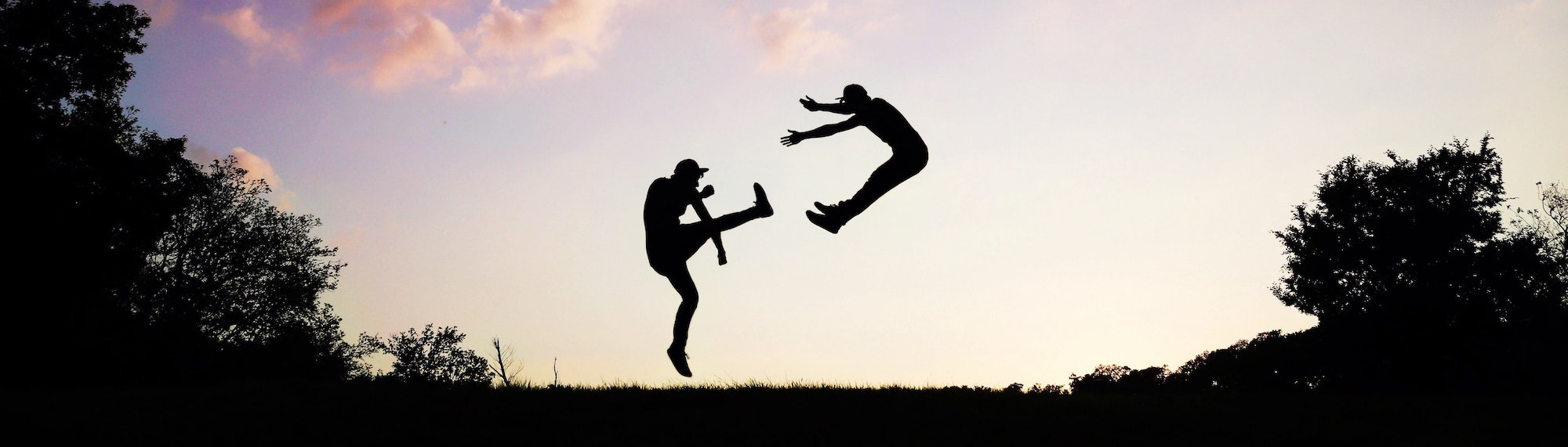 One person kicks the other away.