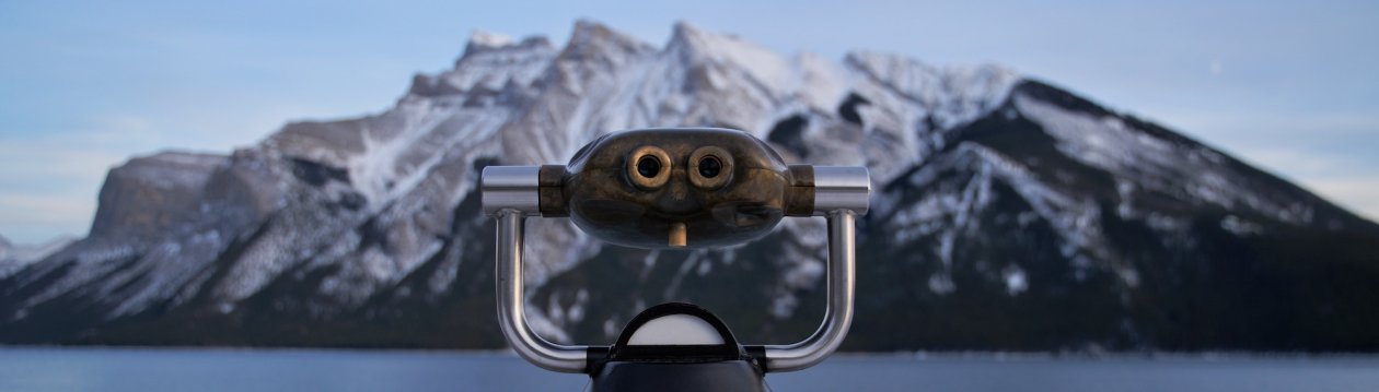 Binoculars pointed at a mountain.