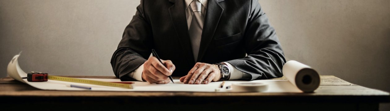 A man sits at a planning board. A man sits at a planning board.