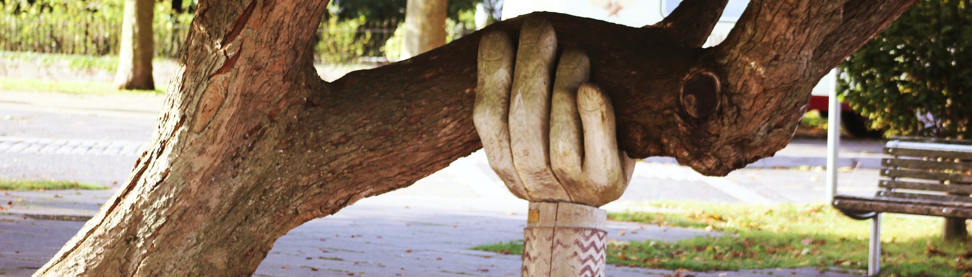 A statue of a hand holding a branch.