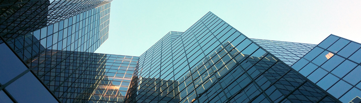 Skyscrapers made of glass, photographed from a worm's-eye view. Skyscrapers made of glass, photographed from a worm's-eye view.