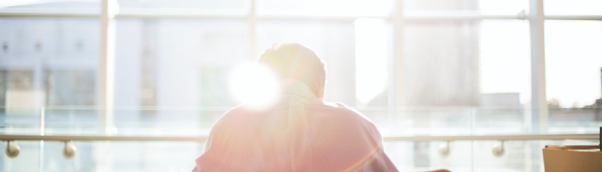 Person sitting in front of a window. [1]