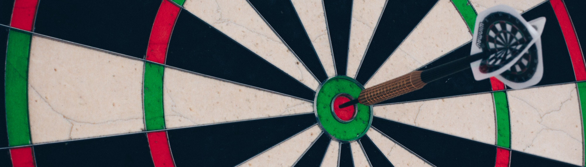 A dartboard. There is a dart in the bullseye.