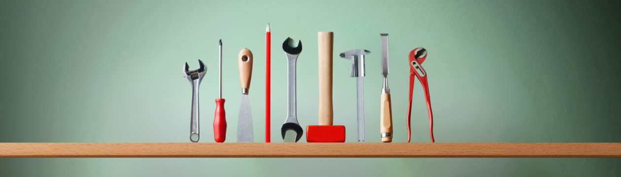 Several tools are on a shelf.