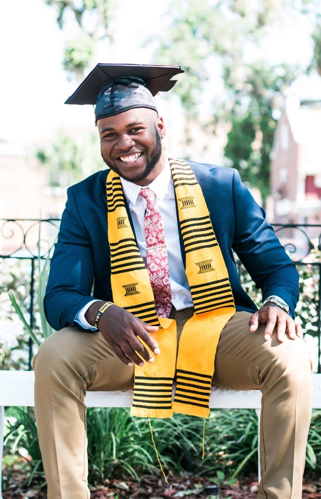 Man in suit and graduation cap. 