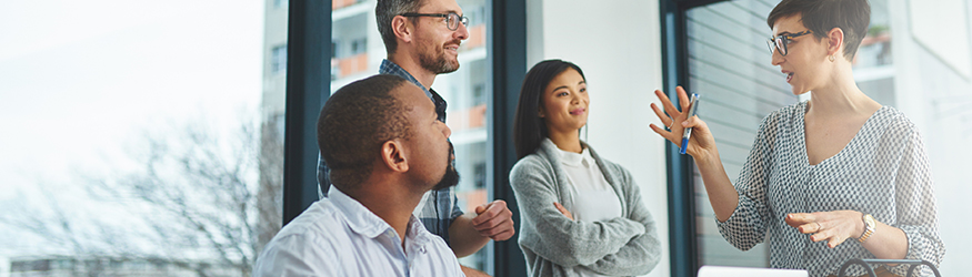 Short-haired woman is explaining something to a small group. Short-haired woman is explaining something to a small group.